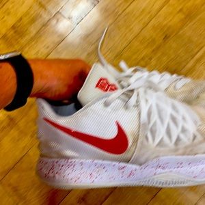 Used white Nike Kyrie men’s basketball shoes.